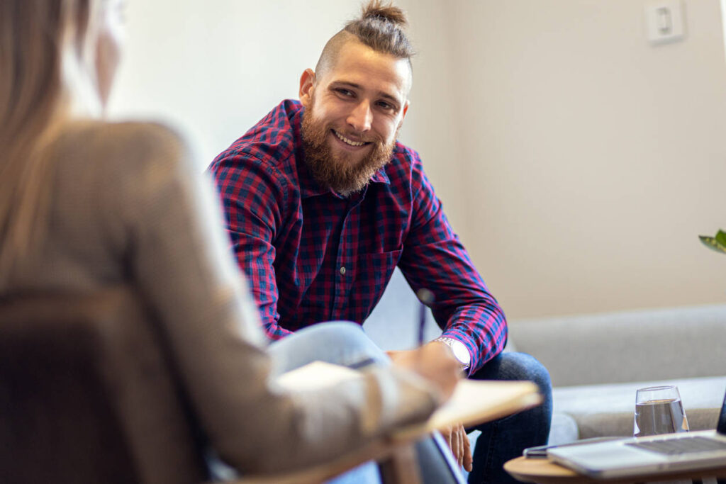Male client talking with a hypnotherapist during a consultation