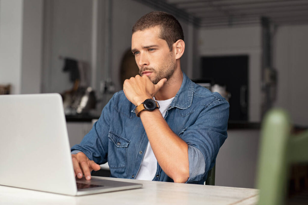 Man researching a hypnotherapist online before booking