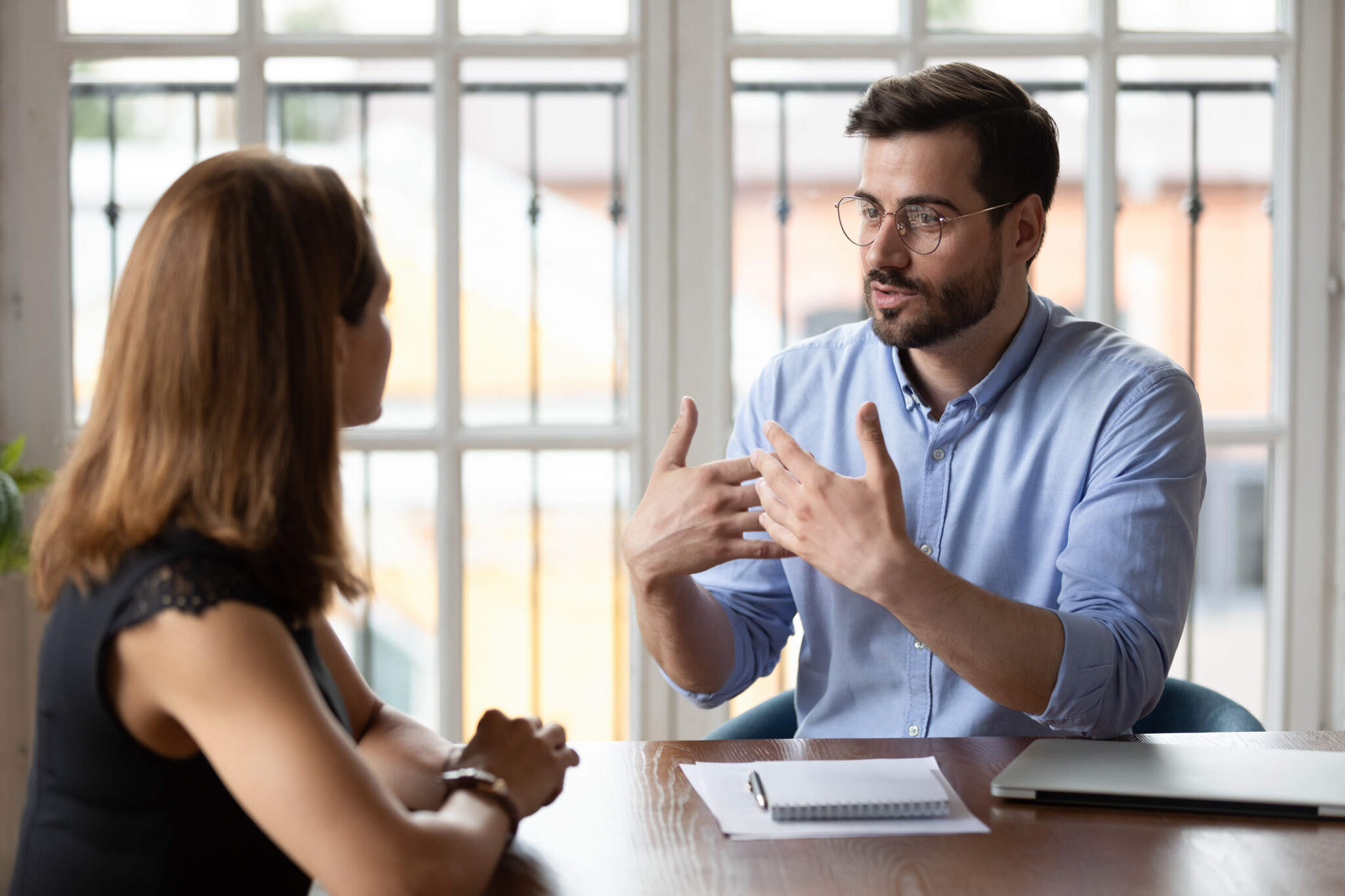 Man and woman having a relaxed conversation across a table